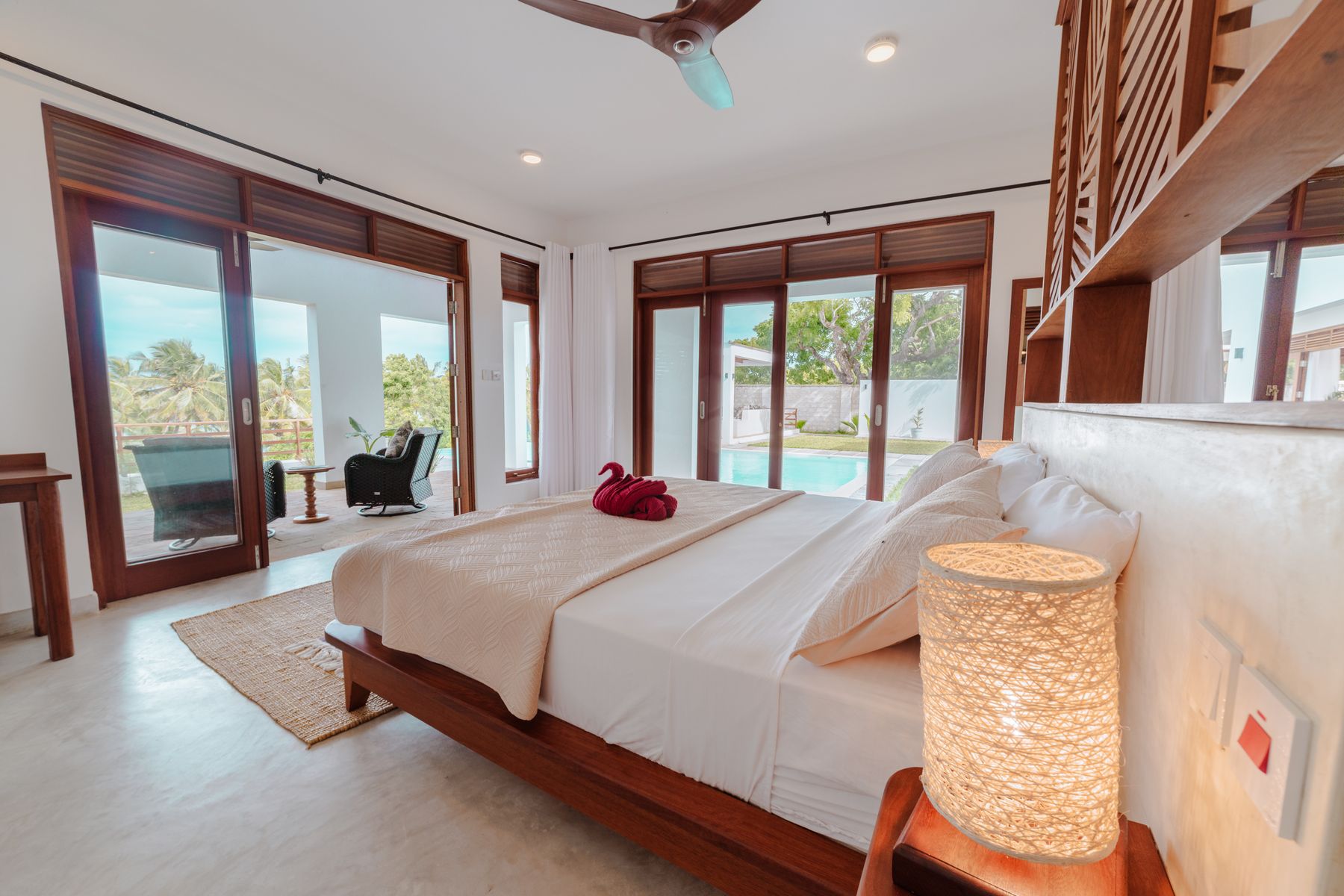 Bedroom with glass doors looking over the pool