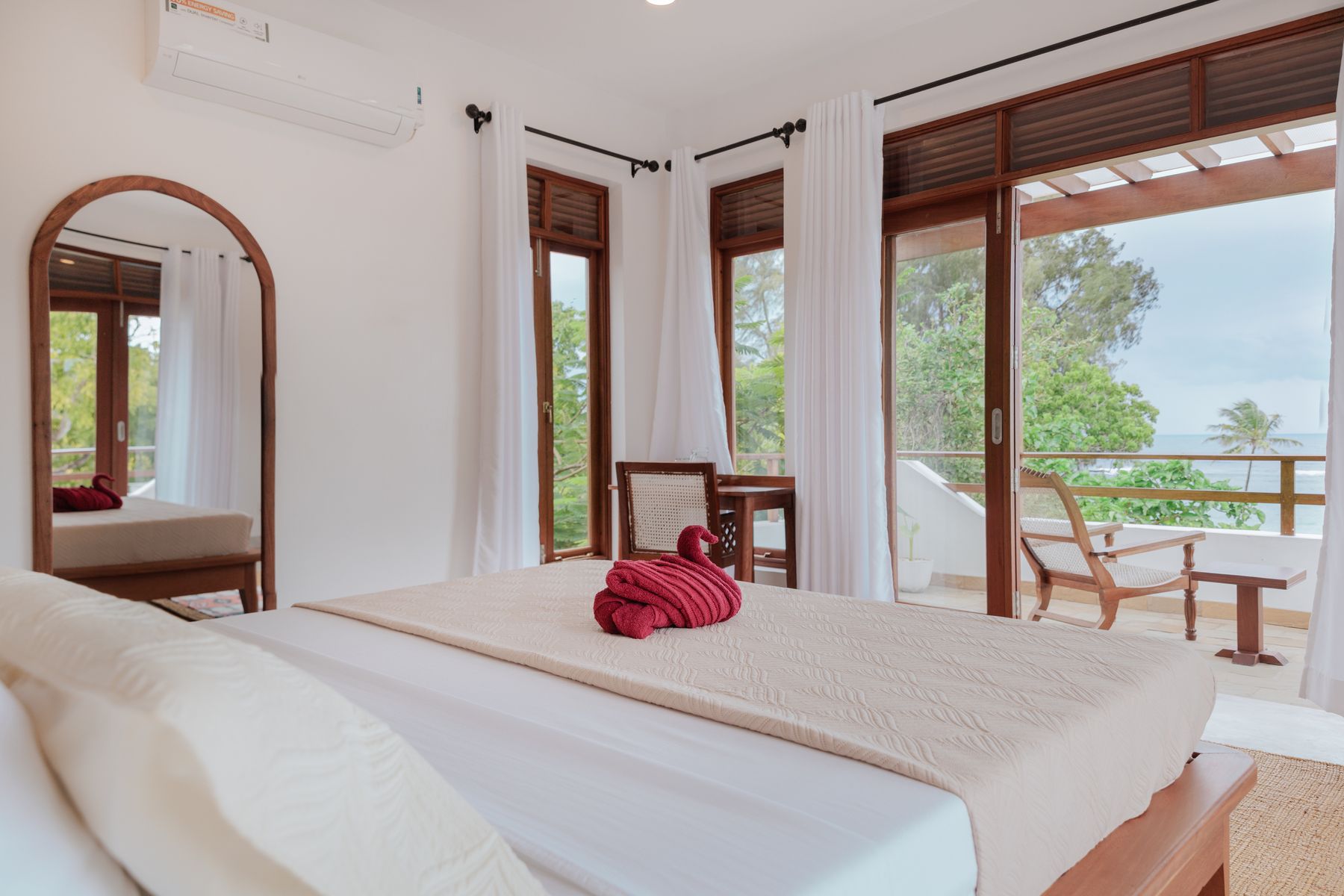 Bedroom with private balcony and ocean view